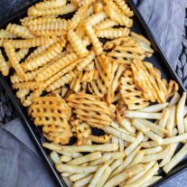 black sheet pan wit Air Fryer Frozen French Fries on gray cloth