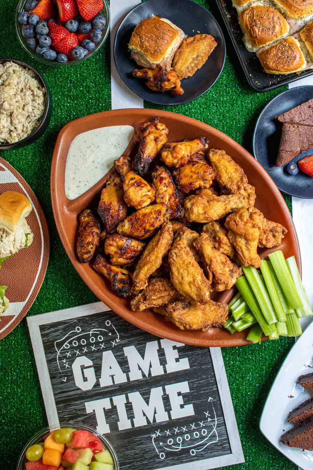 a variety of game day food on a table decorated like a football field