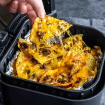 pulling Air Fryer Nachos out of the air fryer