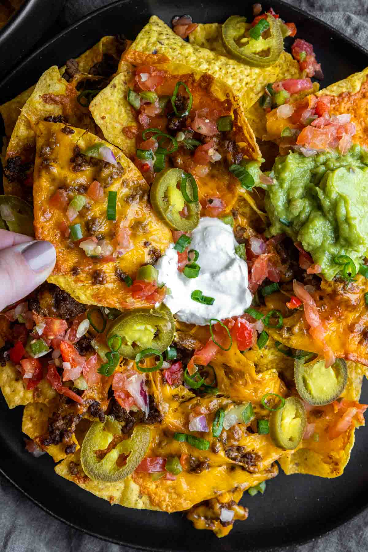 plate of Air Fryer Nachos with jalapenos, sour cream