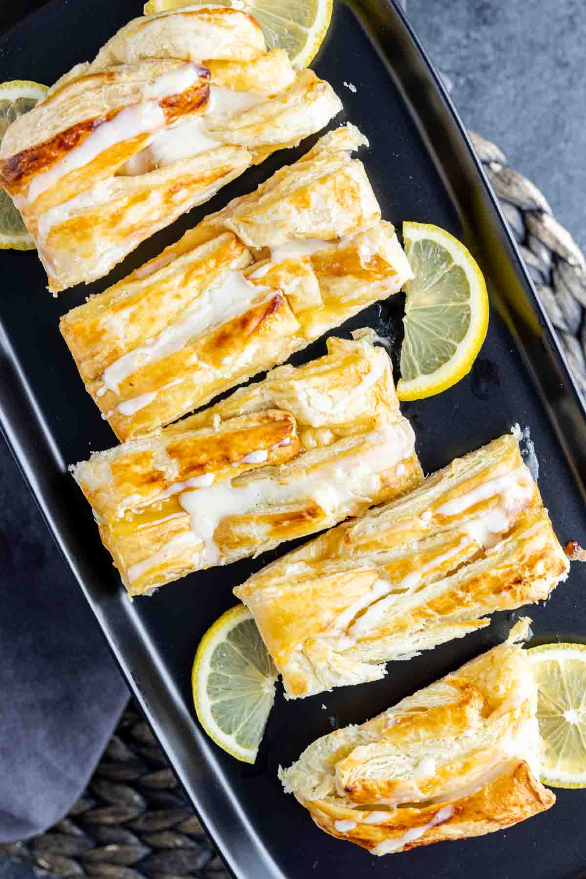 cut Lemon Cream Cheese Danish on platter with lemon slices