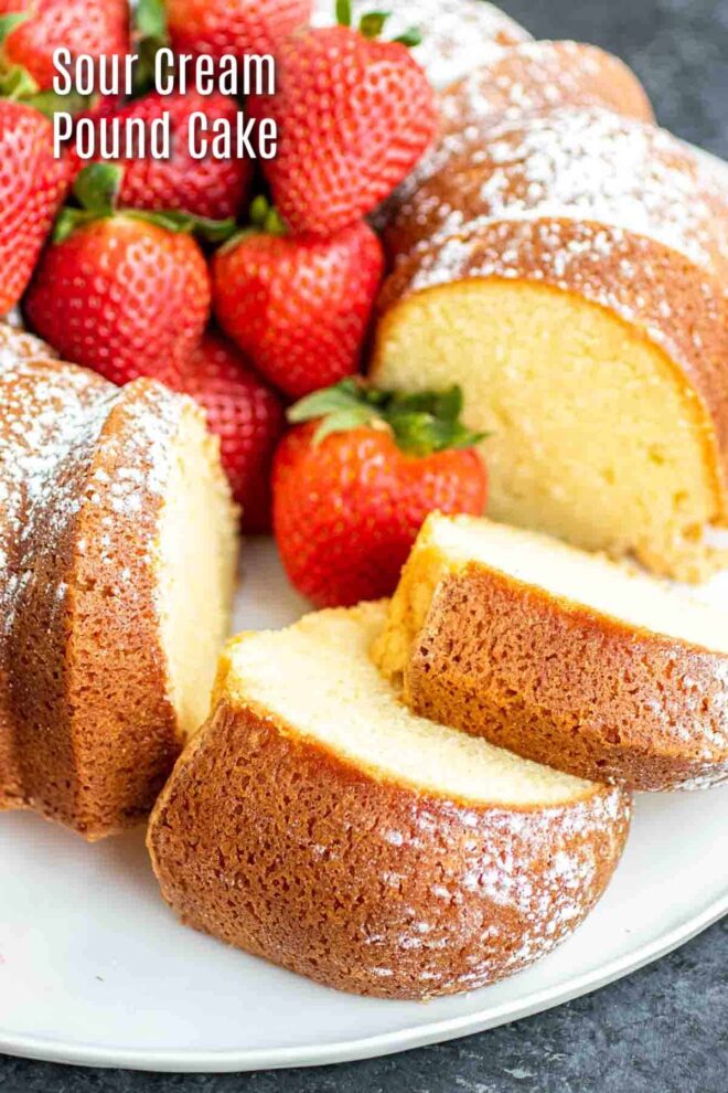pinterest image of Sour Cream Pound Cake on a white platter with fresh strawberries