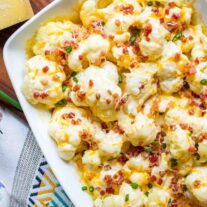 Baked Cauliflower with Cheese Casserole topped sith bacon and scallions