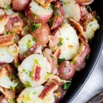 A bowl of potatoes bacon and chives.