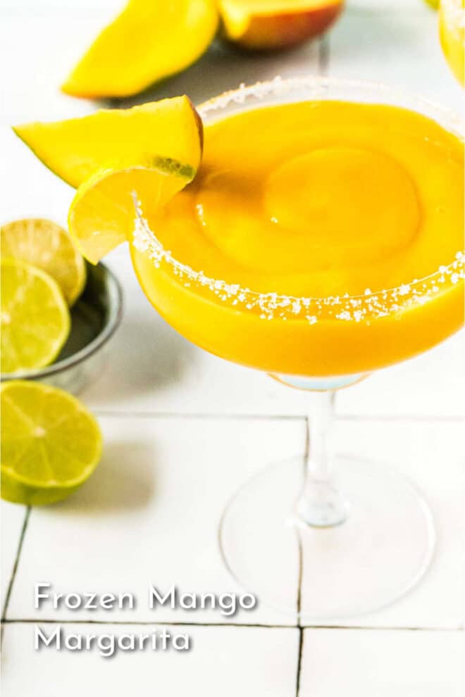 pinterest image of Frozen Mango Margarita in a salted rim in a glass with a lime wedge garnish