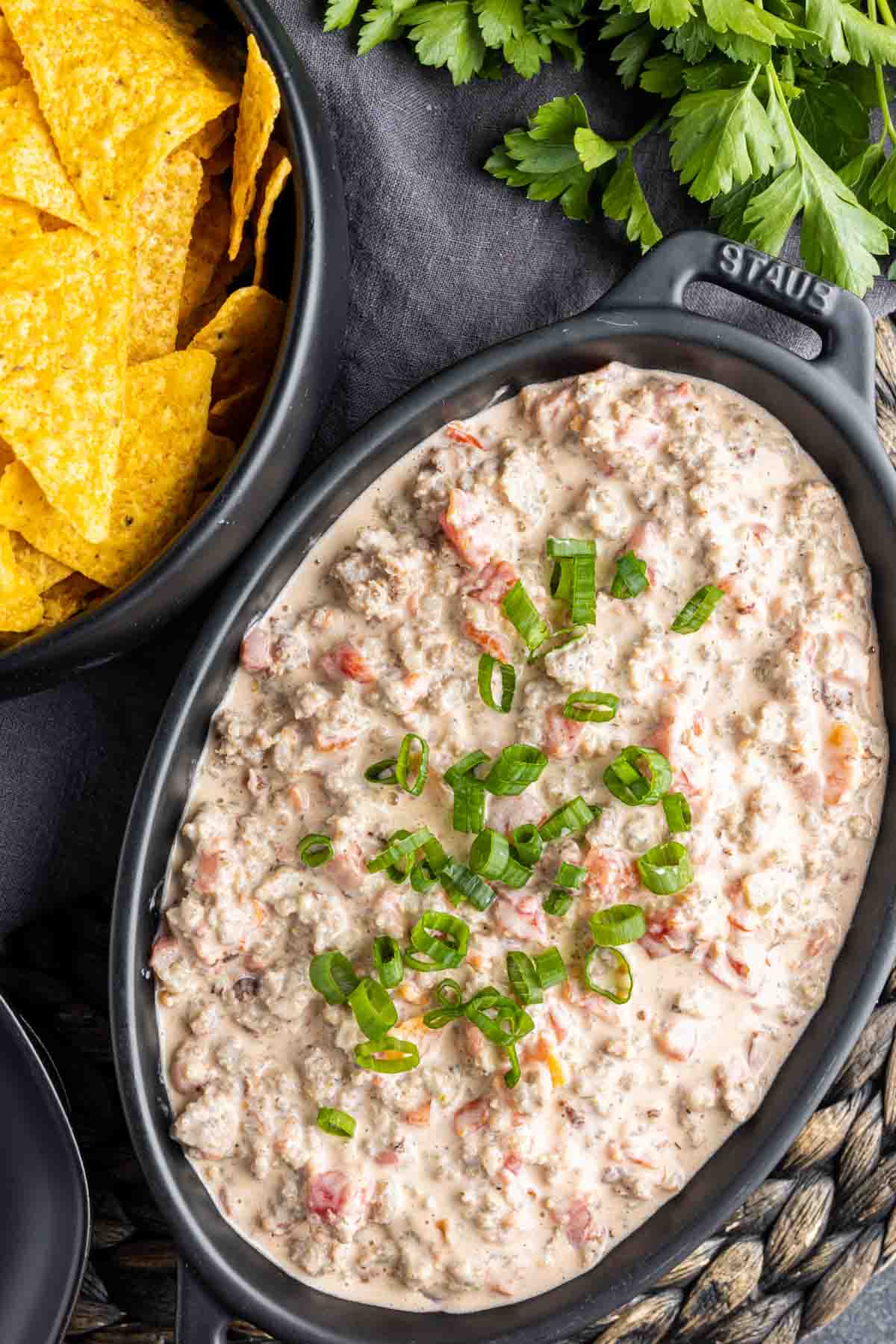 Sausage Cream Cheese Dip in a bowl next to a bowl od tortilla chips