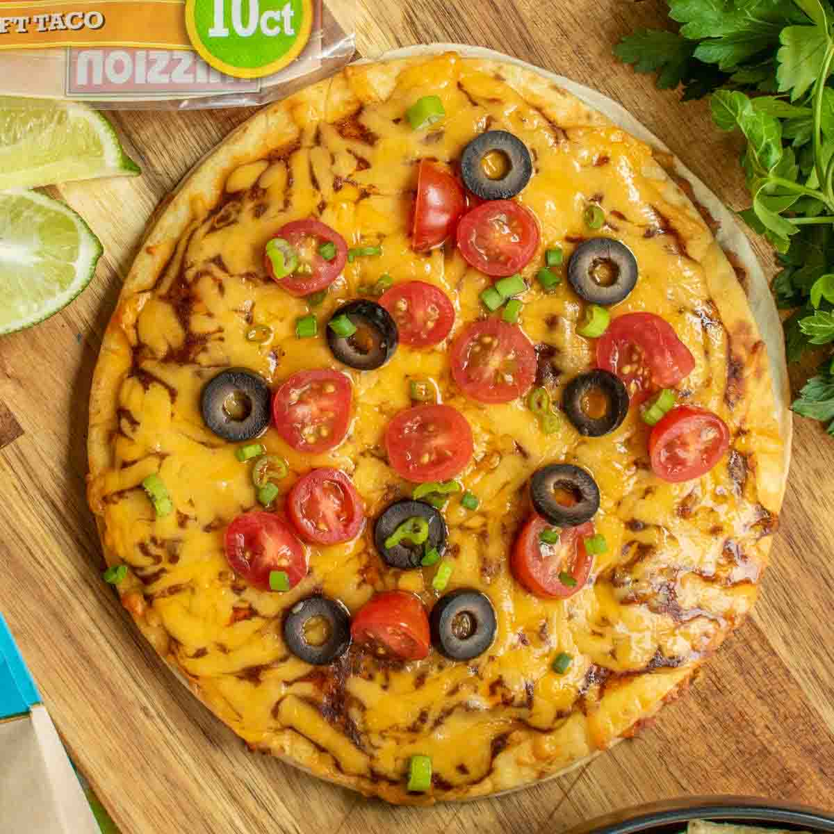 Taco Bell Mexican Pizza layered with refried beans, ground beef and cheese