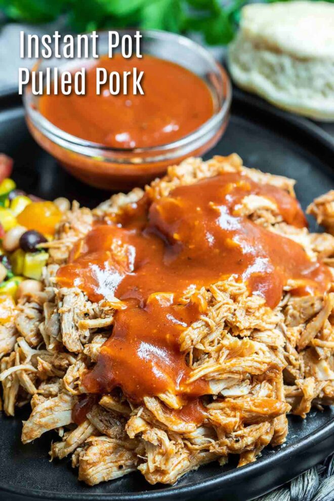 pinterest image of Instant Pot Pulled Pork with BBQ sauce on a black plate