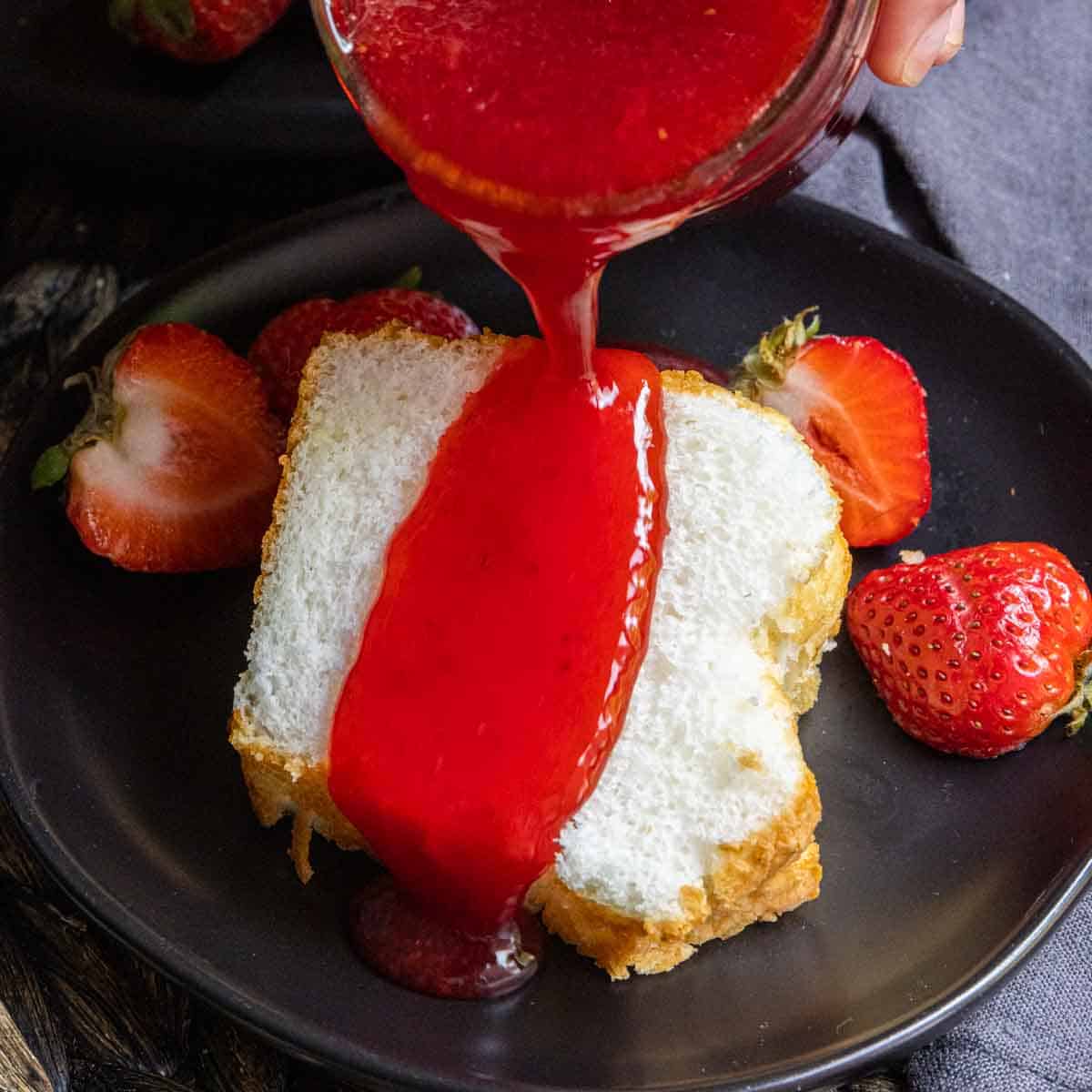cake with Strawberry Coulis being poured on