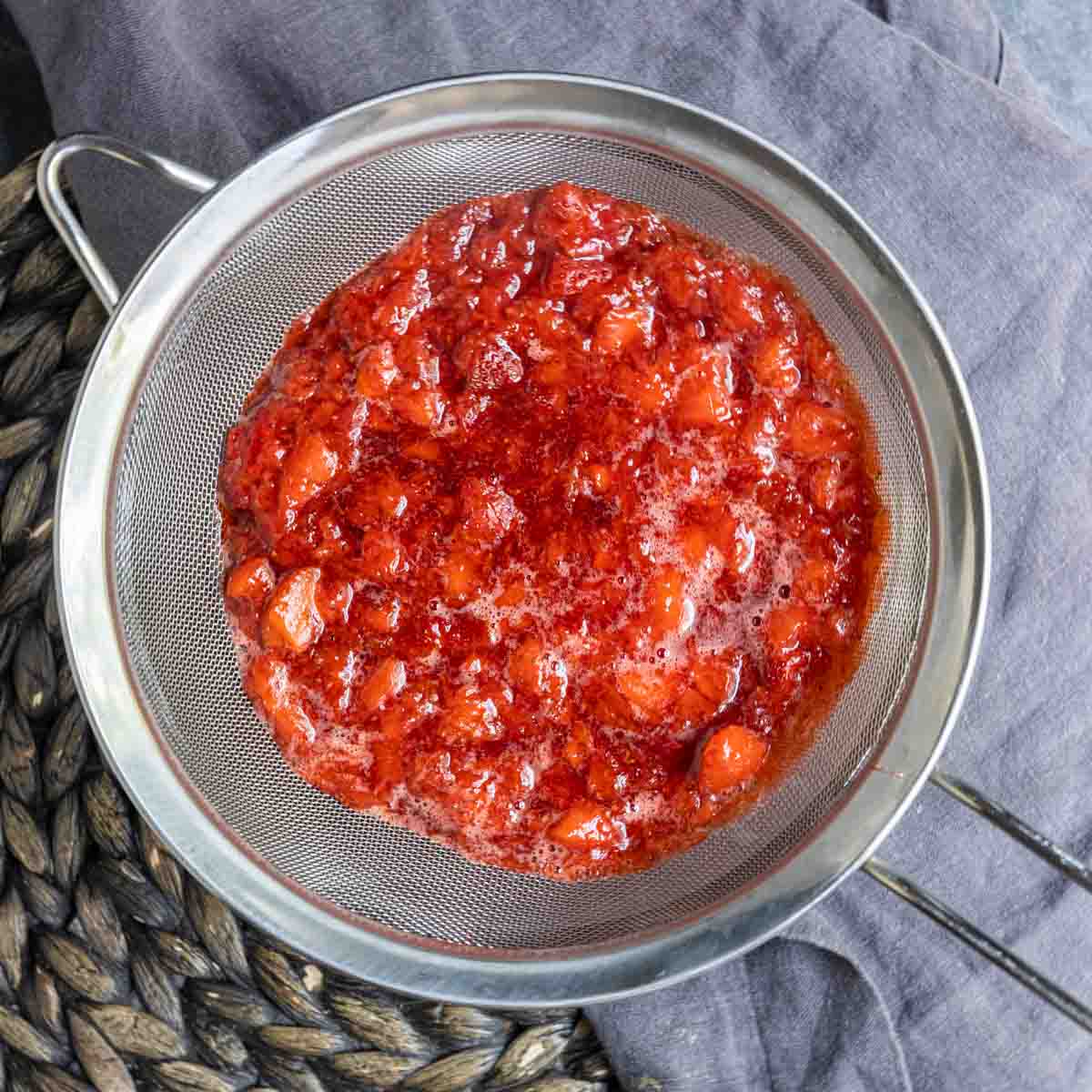 straining Strawberry Coulis through a strainer