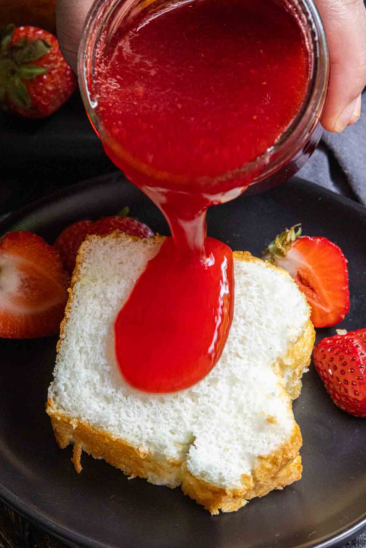 pouring Strawberry Coulis on cake