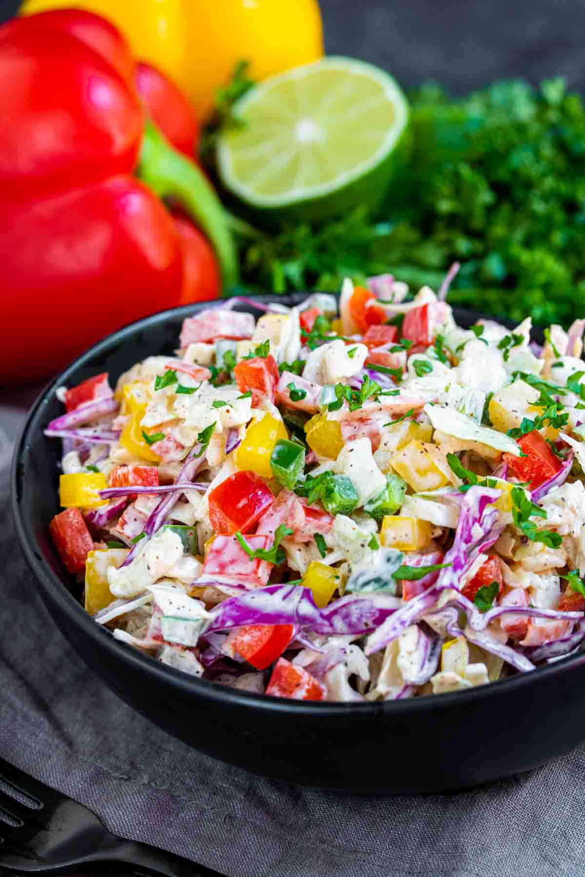 Spicy Jalapeno Coleslaw in a black bowl with bed pepper and lime juice