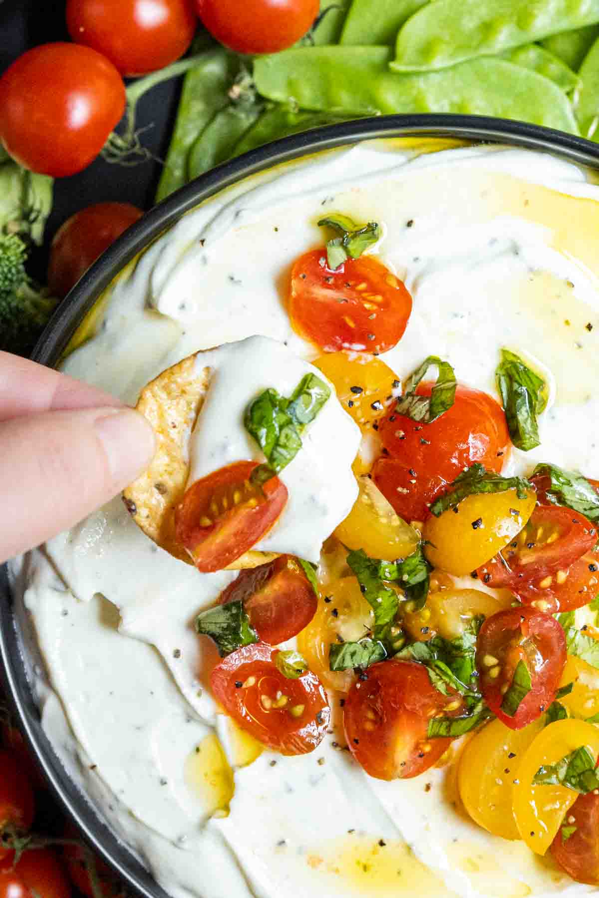 Whipped Ricotta and Tomato Dip on a cracker