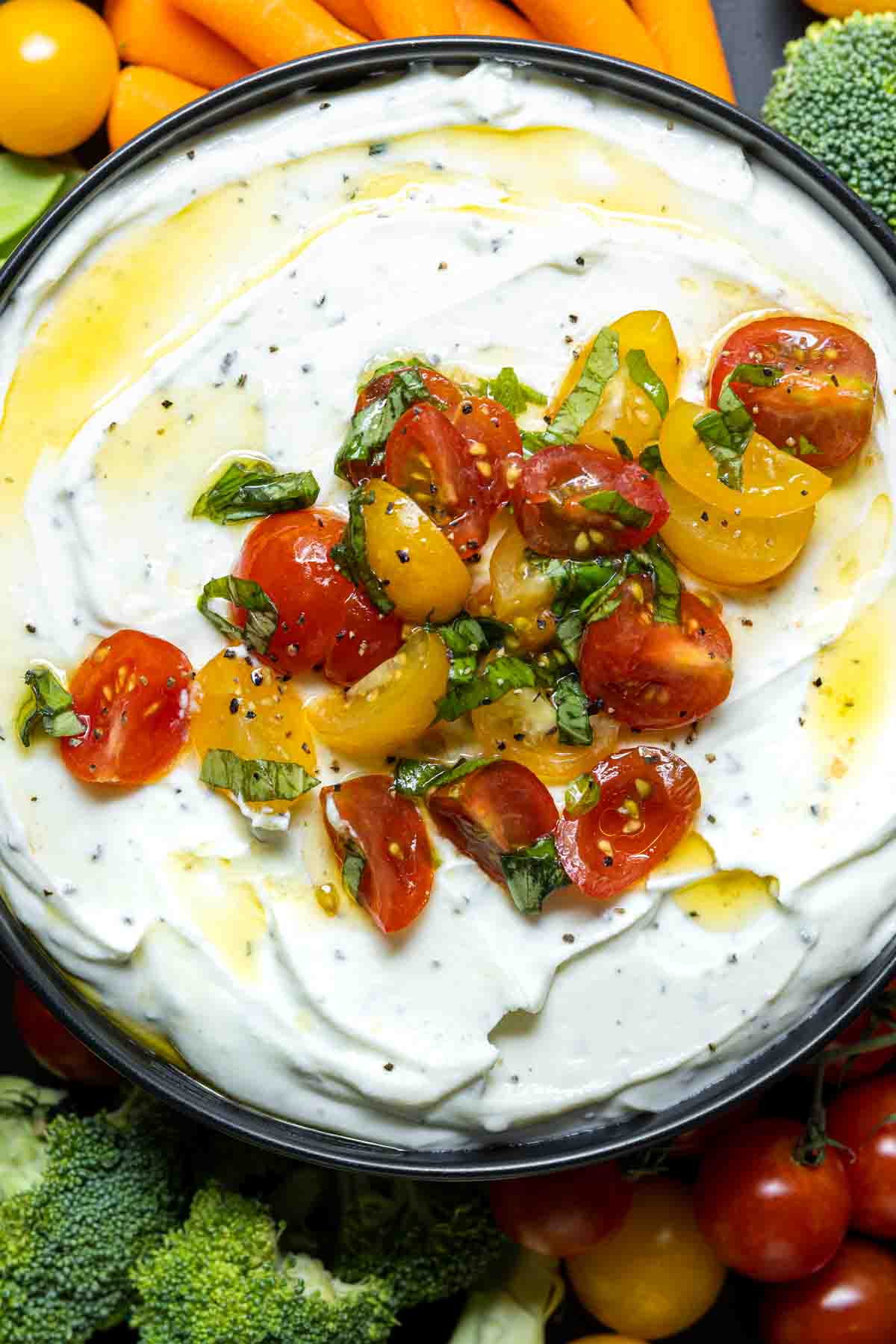 diced tomatoes on top of a bowl of Whipped Ricotta and Tomato Dip