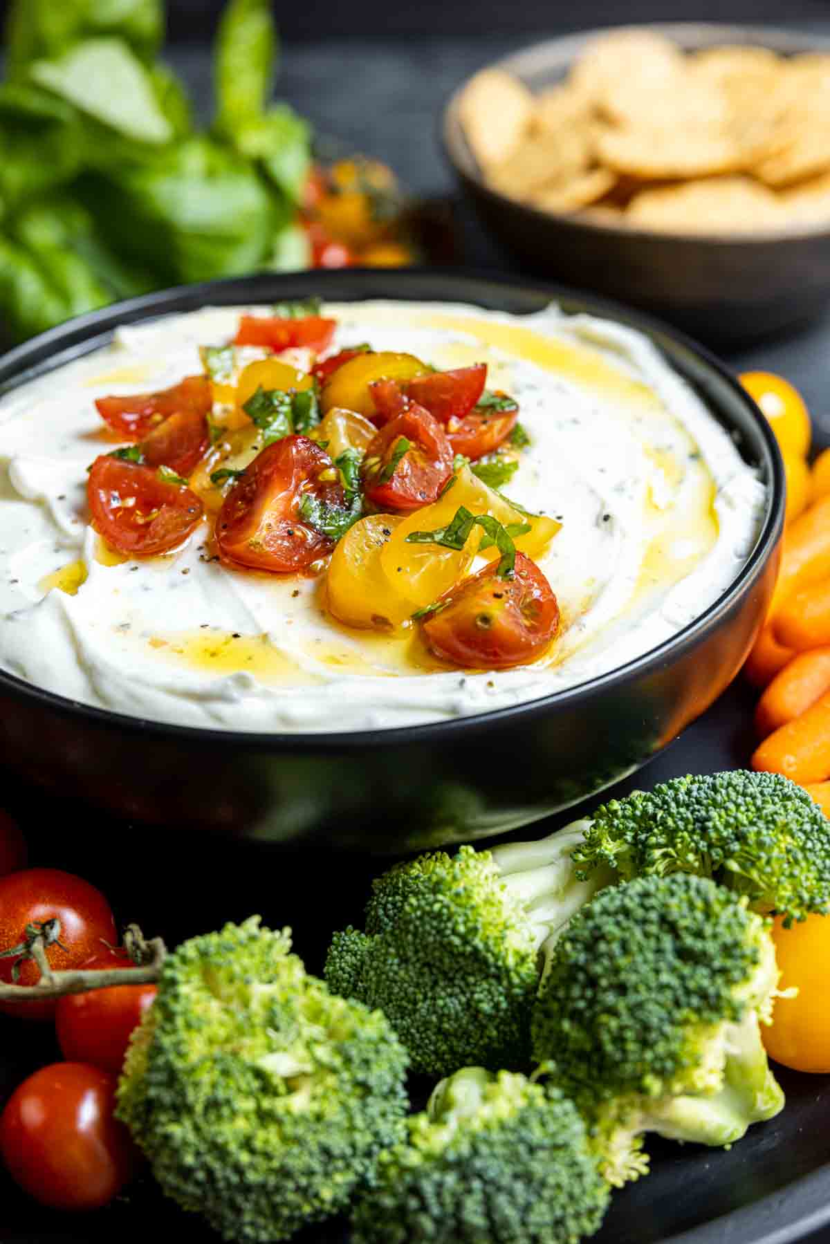 bowl of Whipped Ricotta and Tomato Dip topped with olive oil