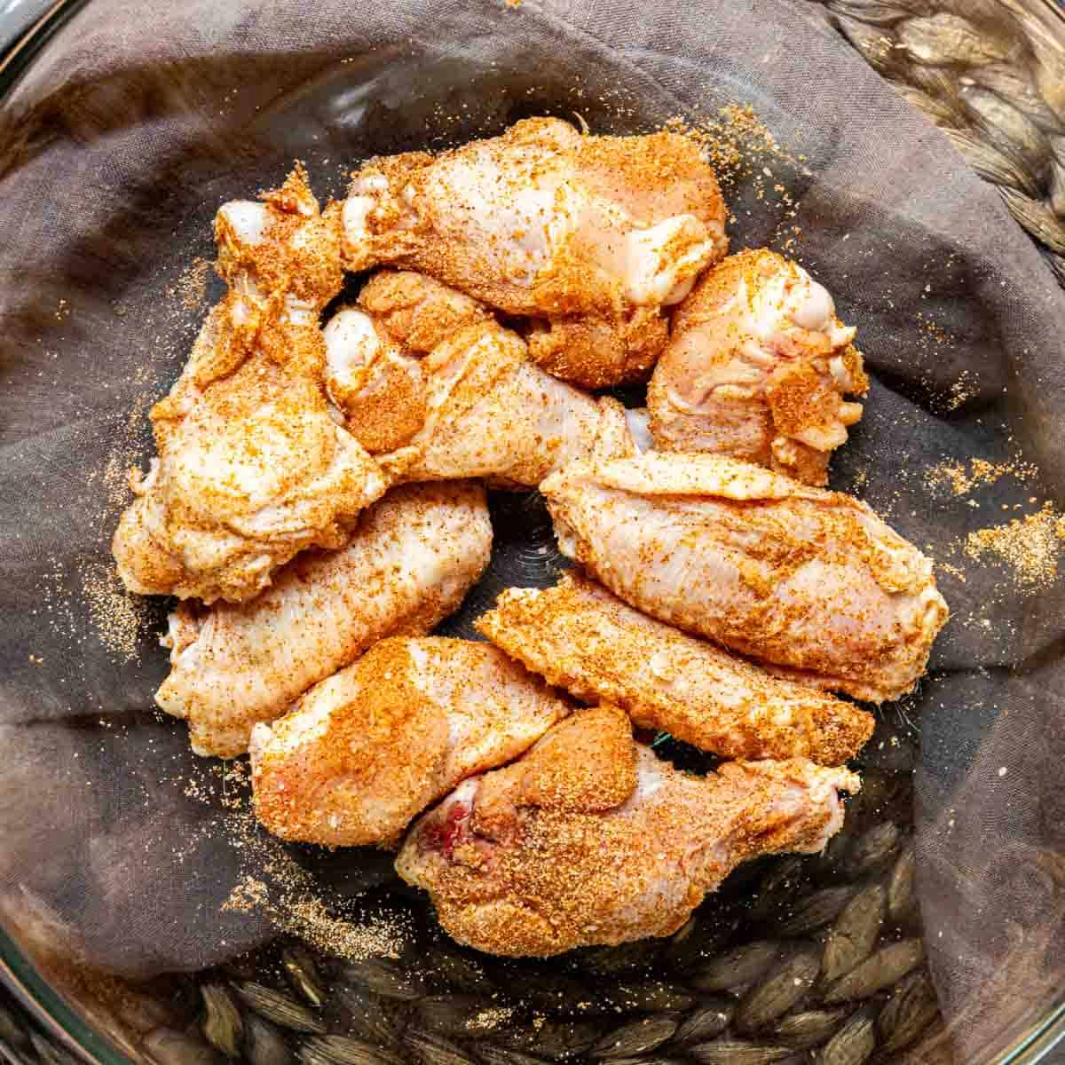 Seasoned chicken wings in a bowl to make Honey Garlic Chicken Wings