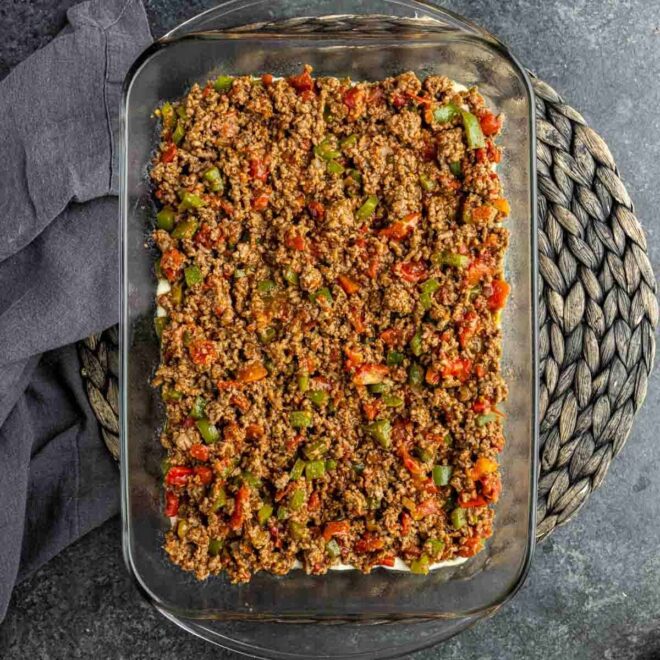 A John Wayne Casserole with meat and peppers in a glass dish.
