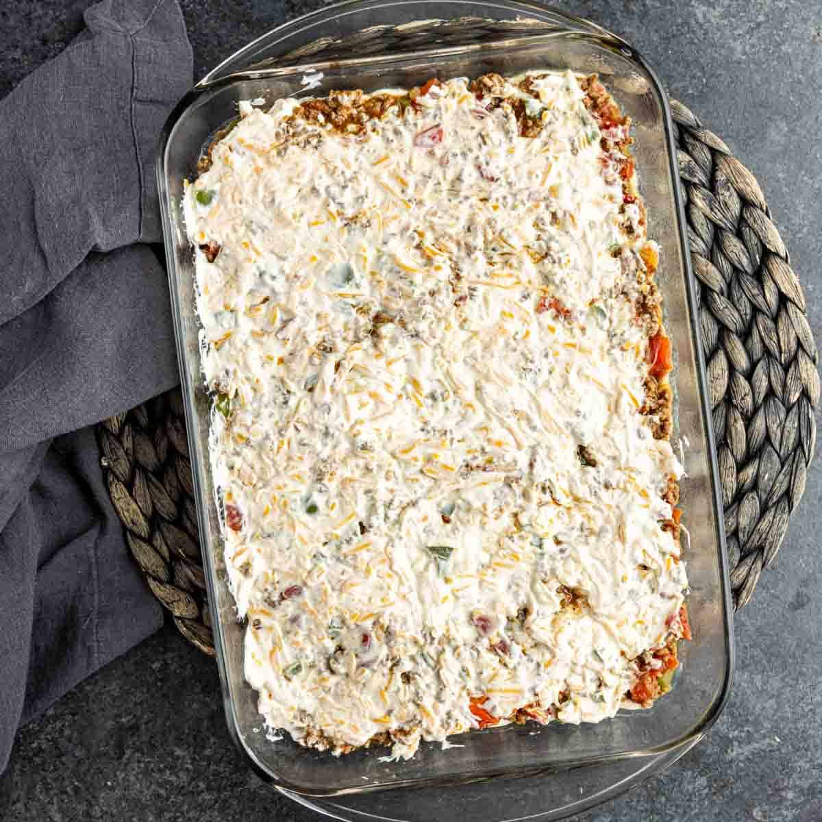 A John Wayne Casserole with cheese and meat layer.