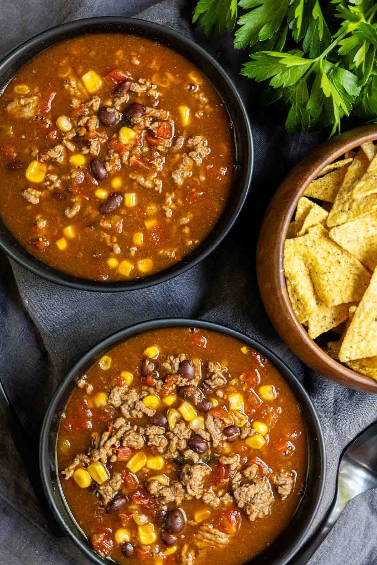 Instant Pot Taco Soup with corn tortillas and tortilla chips.