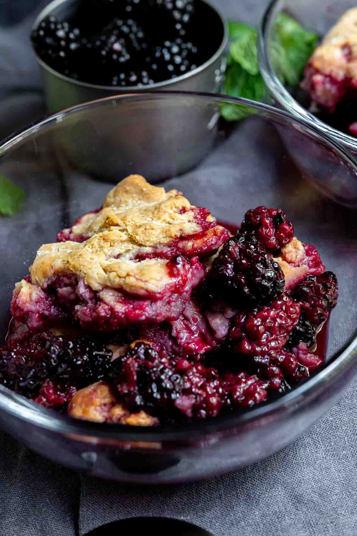easy blackberry cobbler in a glass bowl with gray background