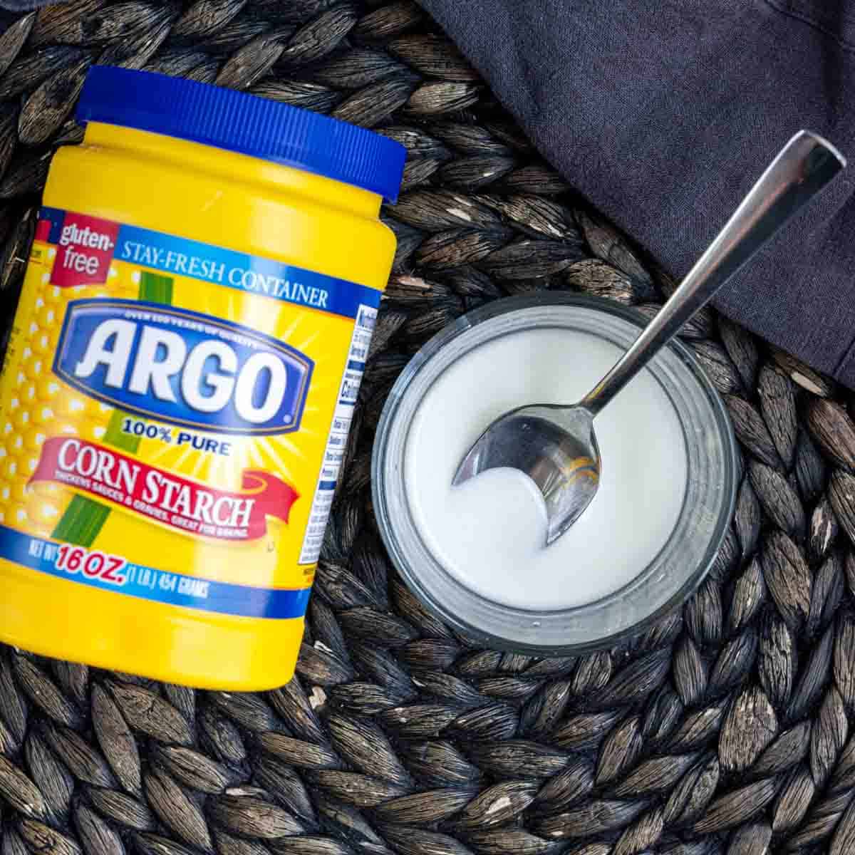 A jar of argo corn syrup next to a spoon to make apple pie filling
