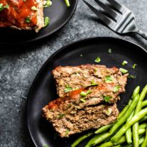 Keto Meatloaf on a plate with green beans and a fork.