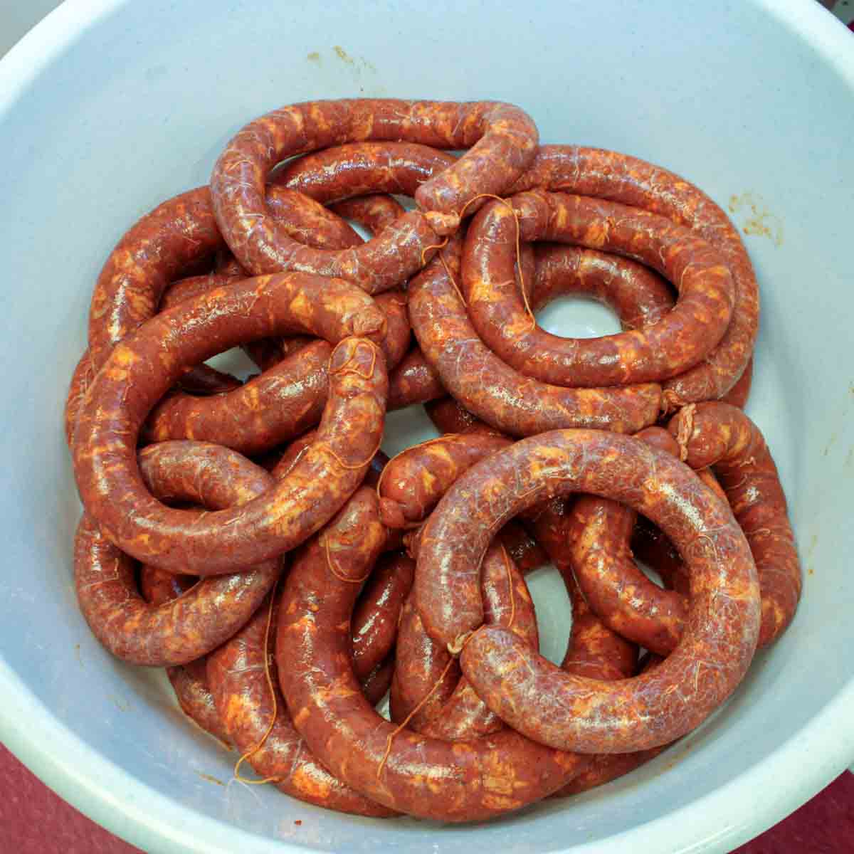 A bowl of sausages in a white bowl.