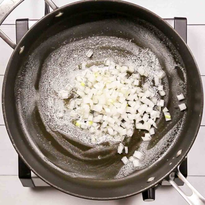 A frying pan with onions to make Creamed Corn