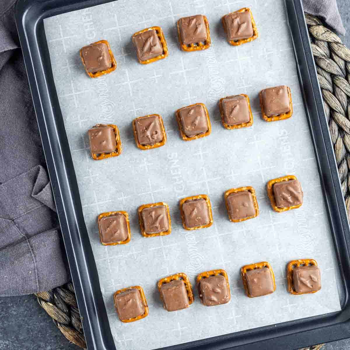 Snickers Pretzel Bites on a baking sheet.