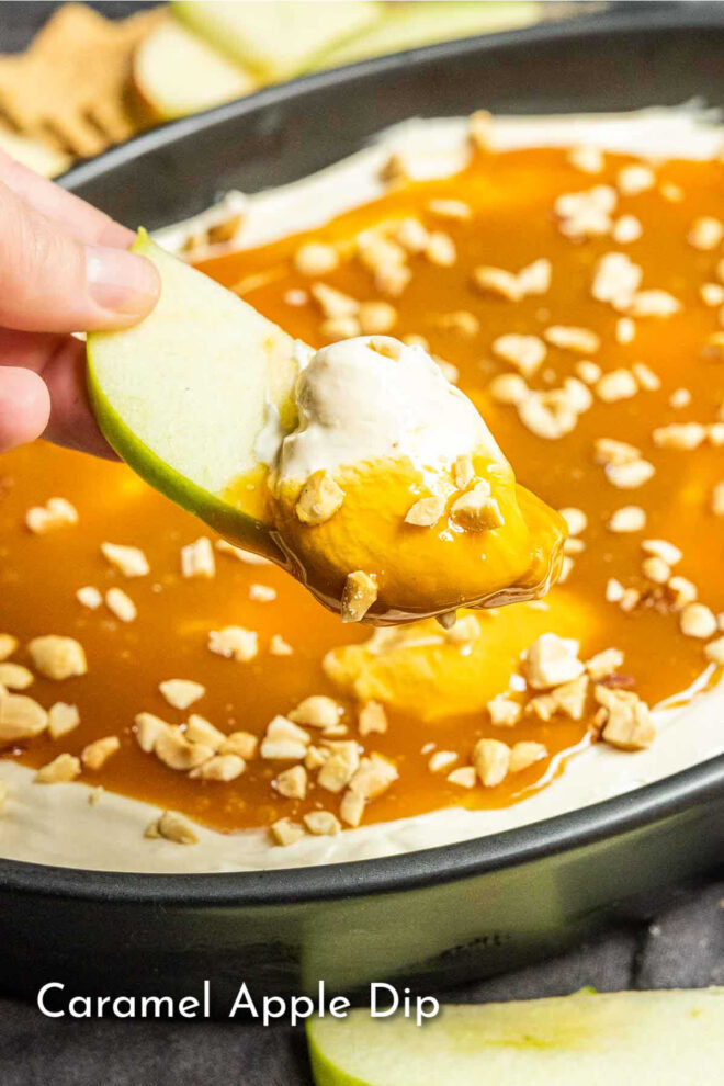 Caramel apple dip in a pan with an apple dipped in caramel.