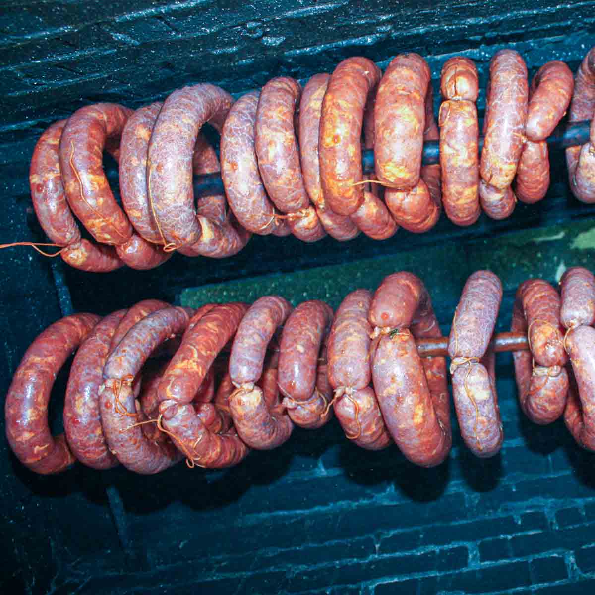 Portuguese sausage are being smoked in smoker outside