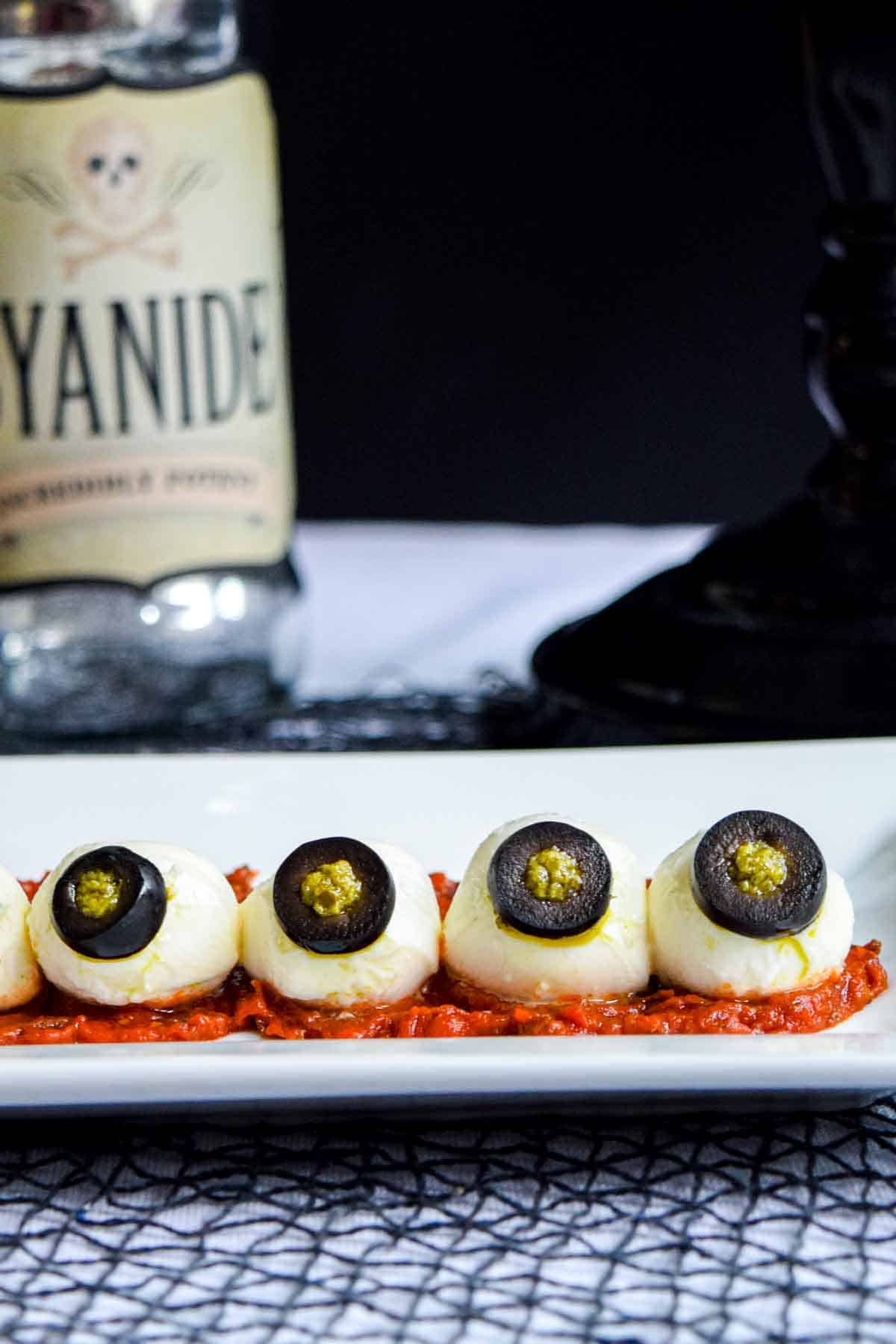 A plate of halloween eyeballs with olives and black olives.