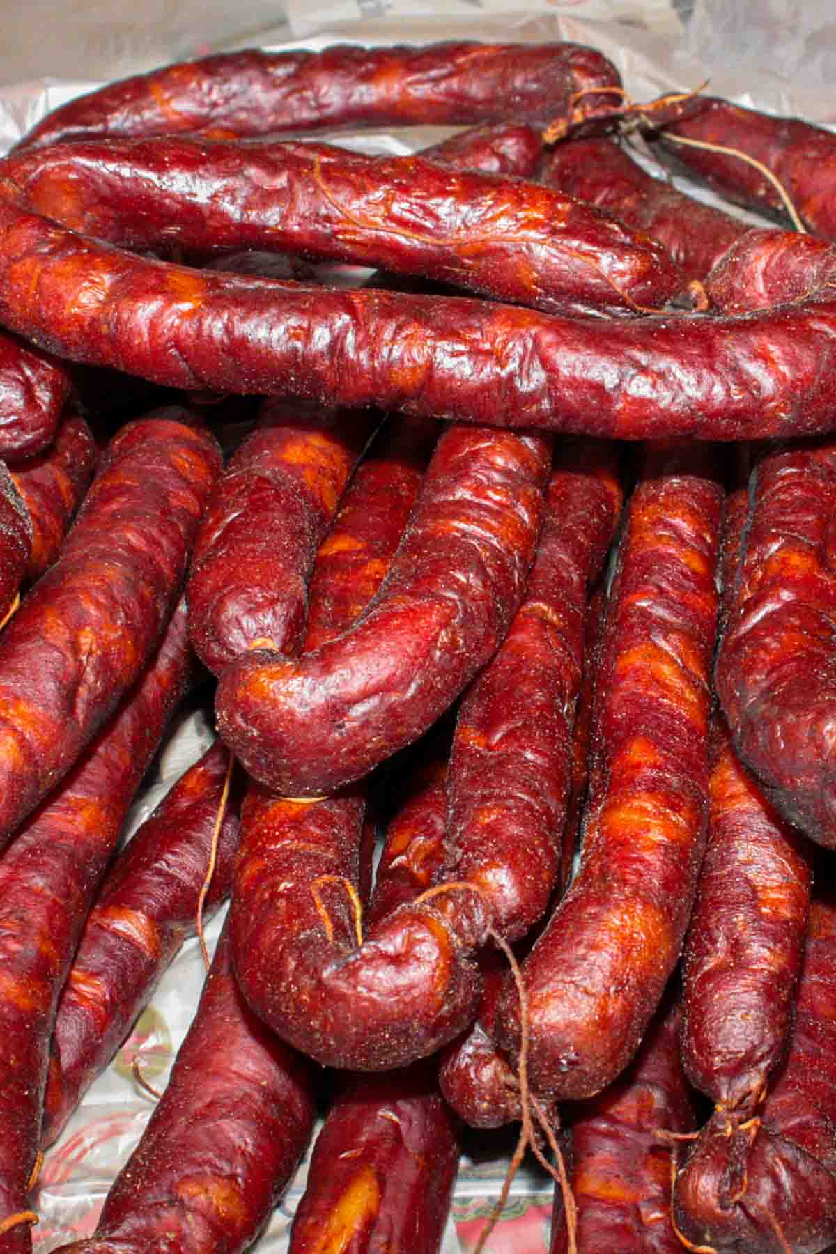 A pile of dried Portuguese sausage on a table.