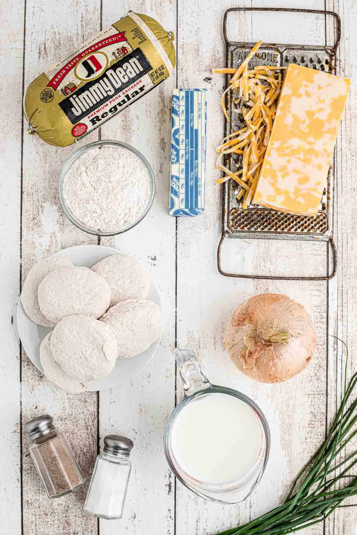 A table with ingredients for a Biscuits and Gravy Casserole