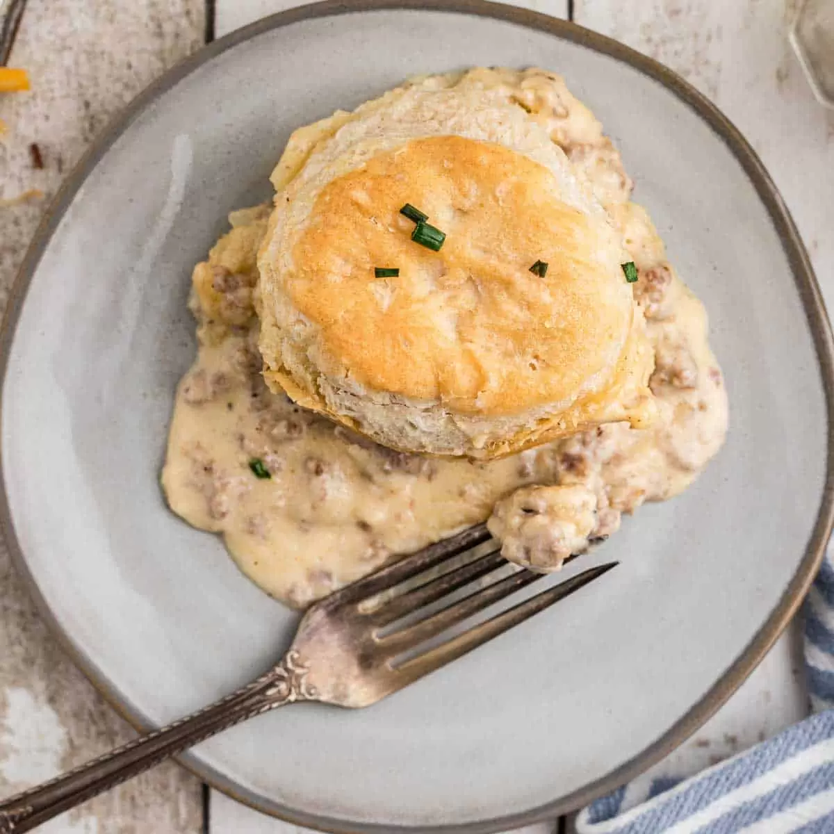 A plate withbiscuits and gravy casserole on it.