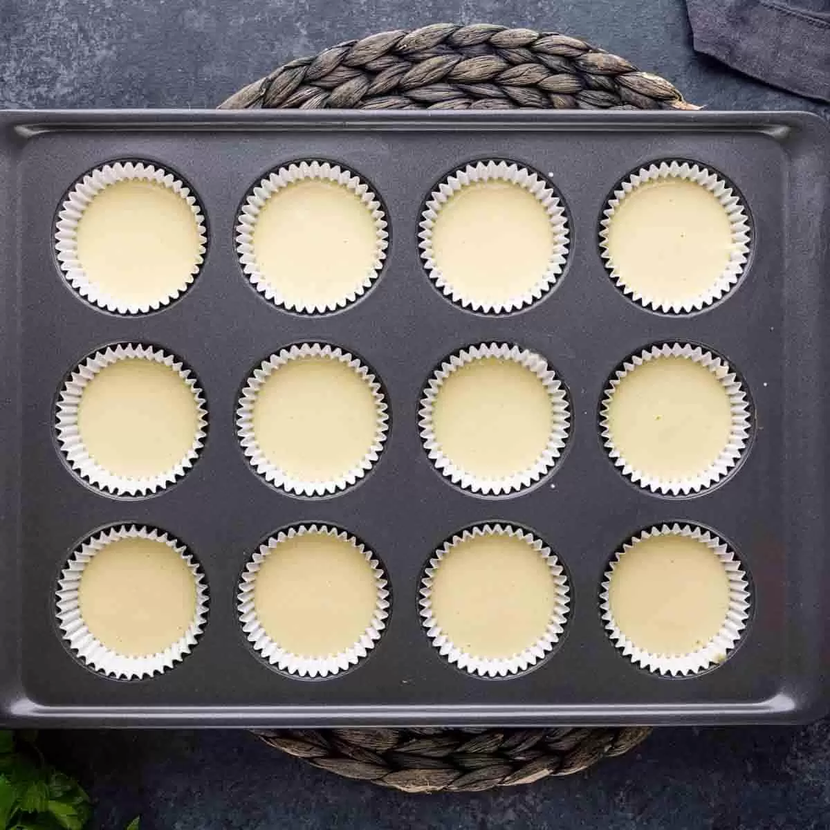 A muffin tin filled with Mini cheesecake cupcakes.