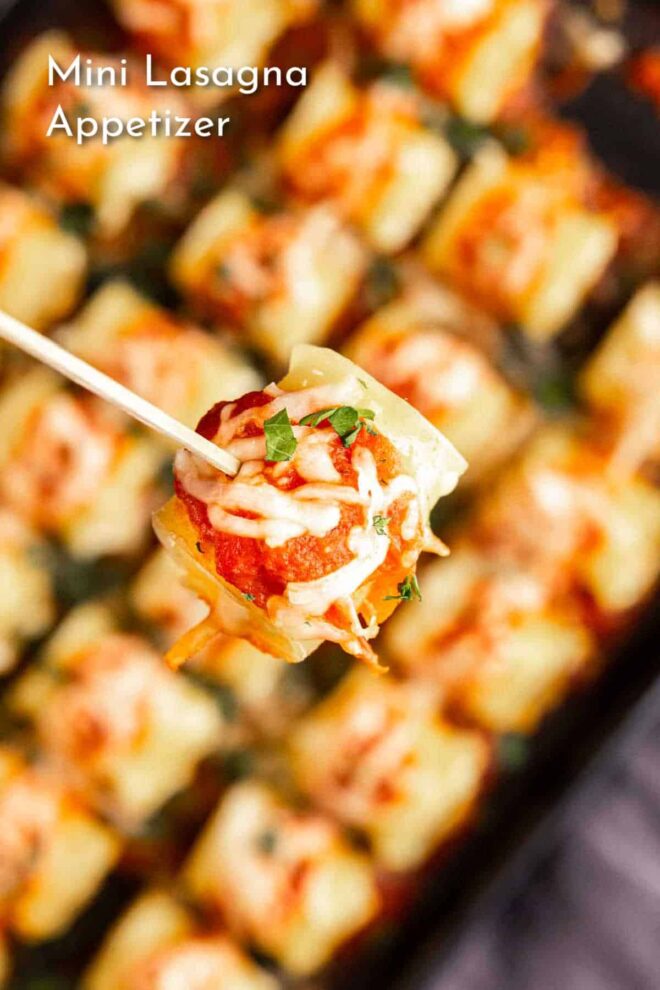 Mini lasagna appetizers on a tray with a toothpick.