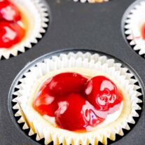 Cherry cupcakes in a muffin tin.