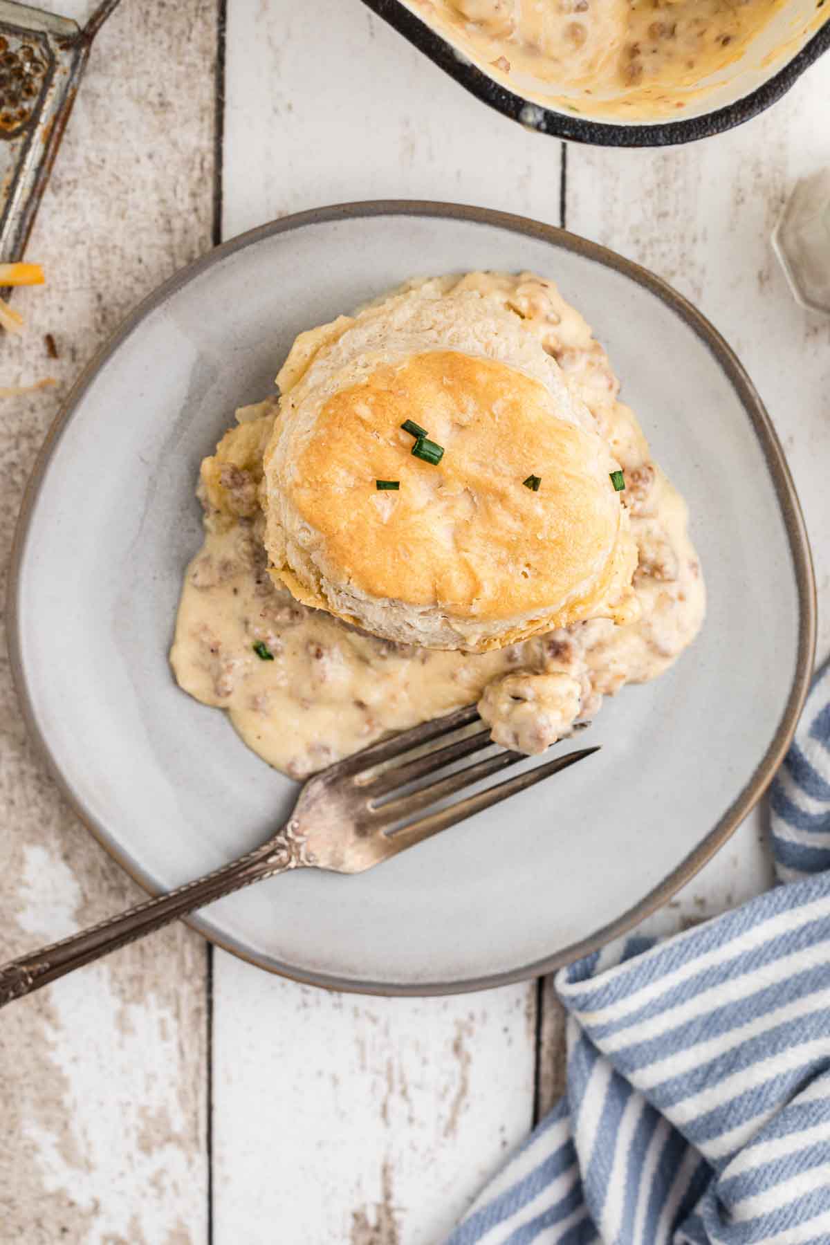 A plate with a biscuits and gravy casserole on it.
