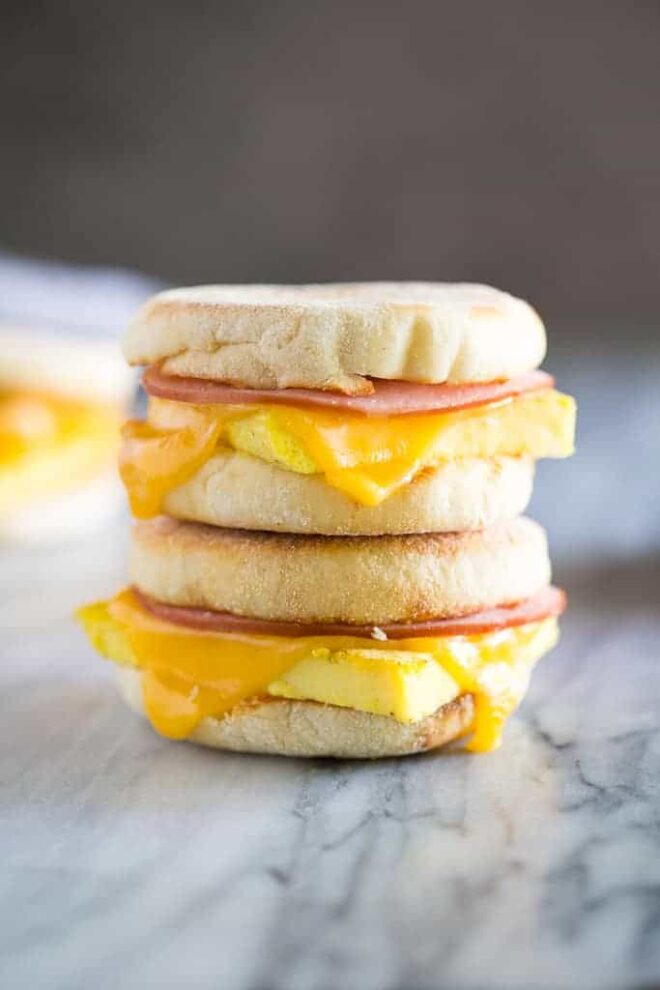 A stack of breakfast sandwiches with ham and cheese.