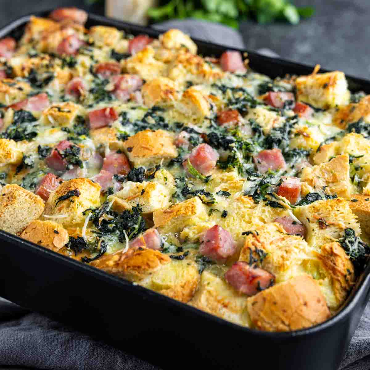 Ham and Cheese Strata in a black baking dish.