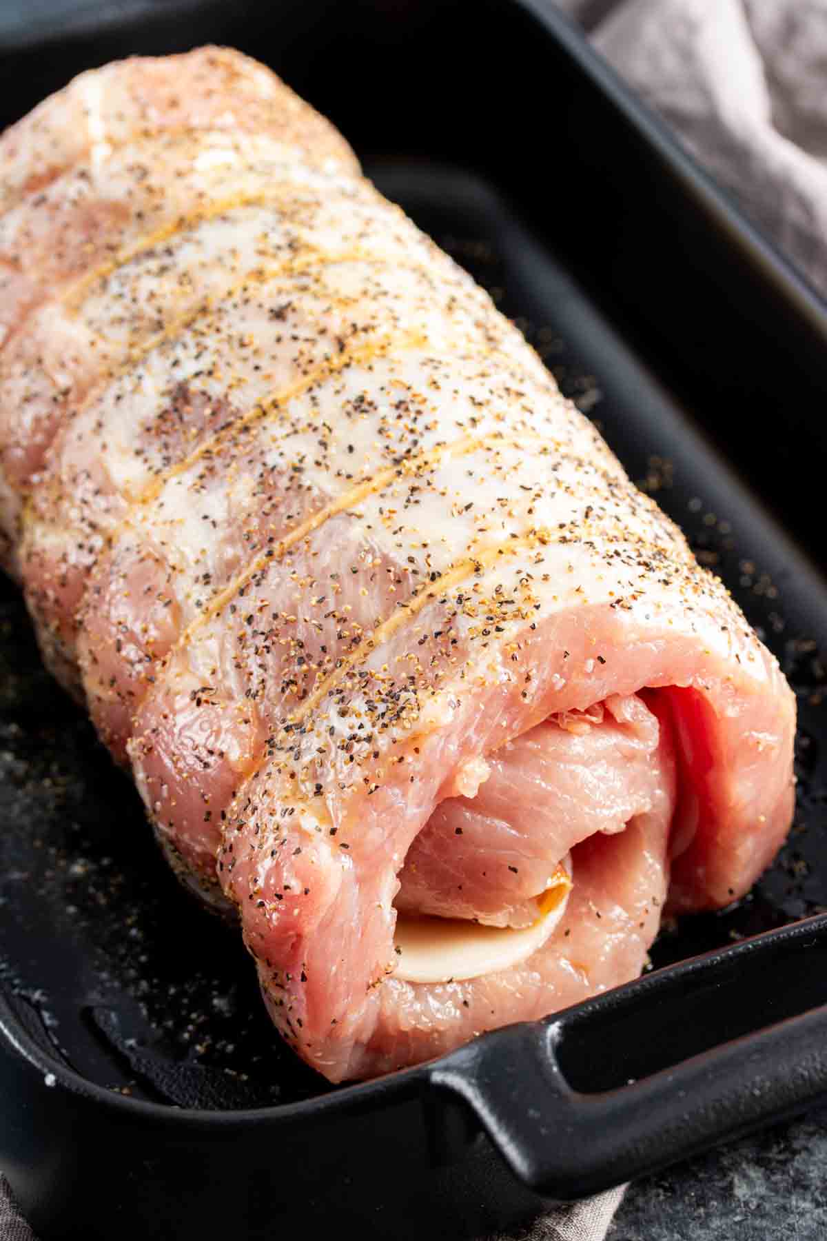 Provolone and Prosciutto Stuffed Pork Loin in a baking pan.