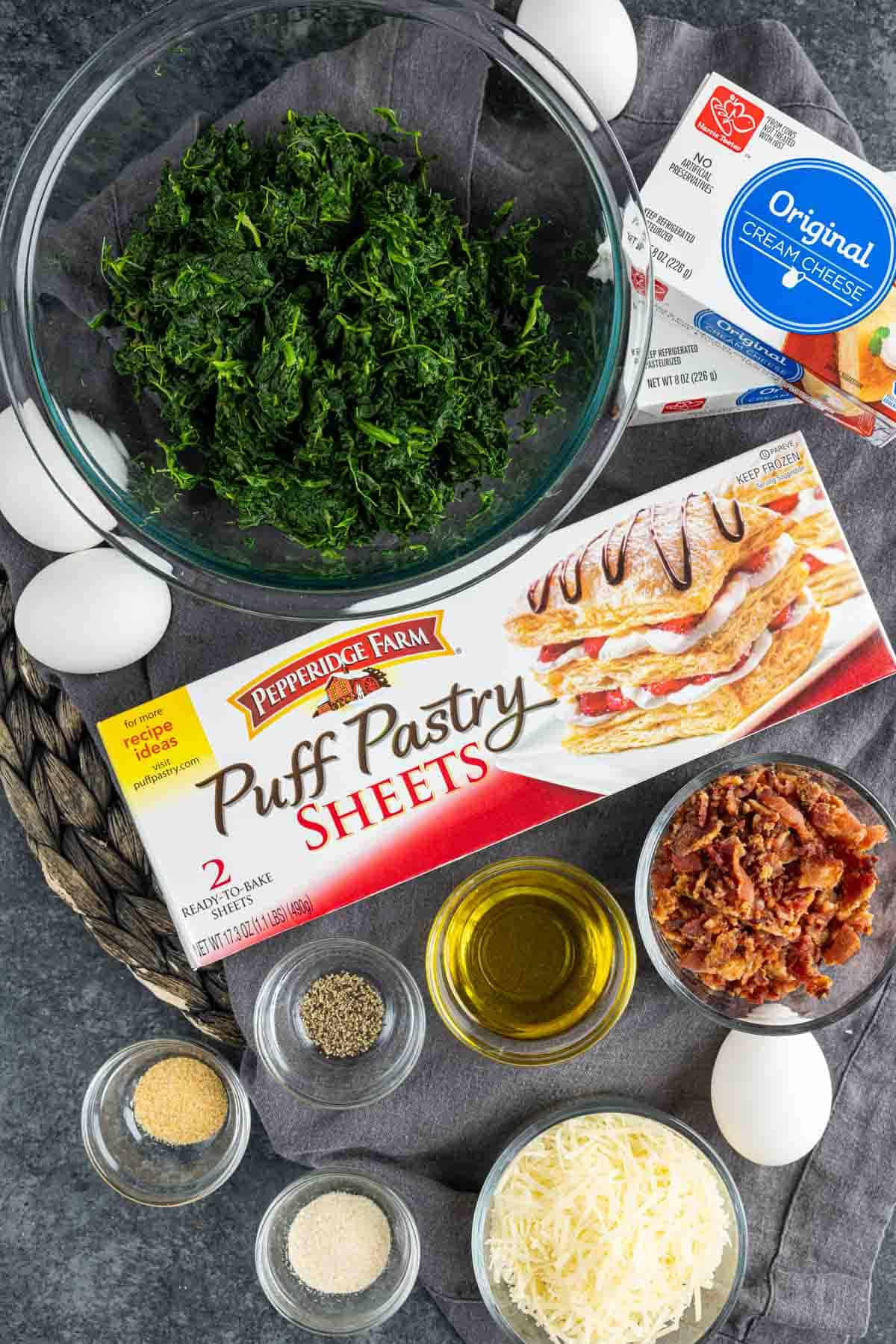 Ingredients for Spinach Puffs, puff pastry sheets with spinach, eggs and cheese.