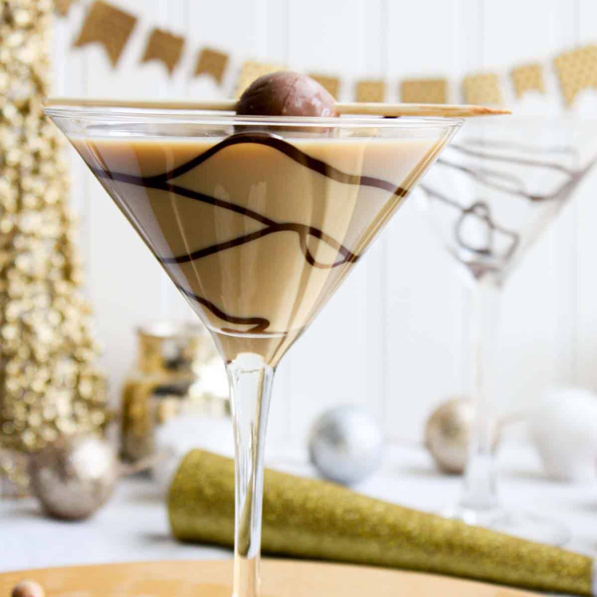 A chocolate martini with chocolate and gold decorations.