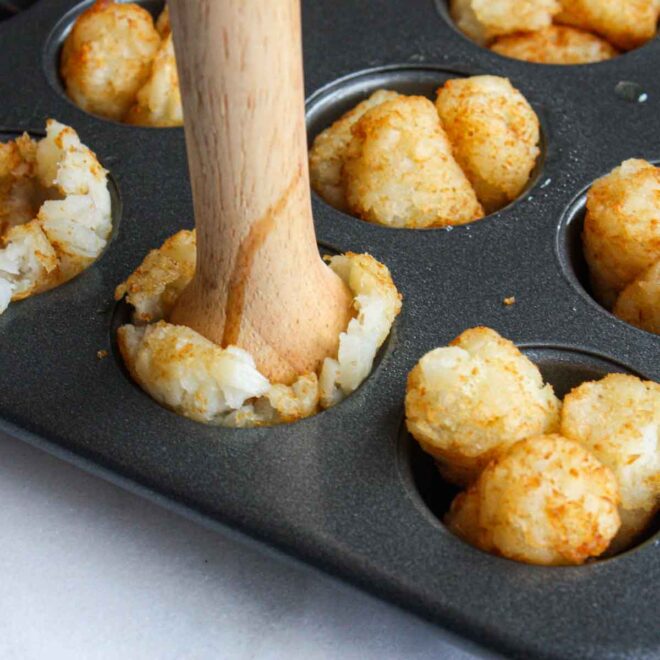 A muffin tin filled with Cheeseburger Tots