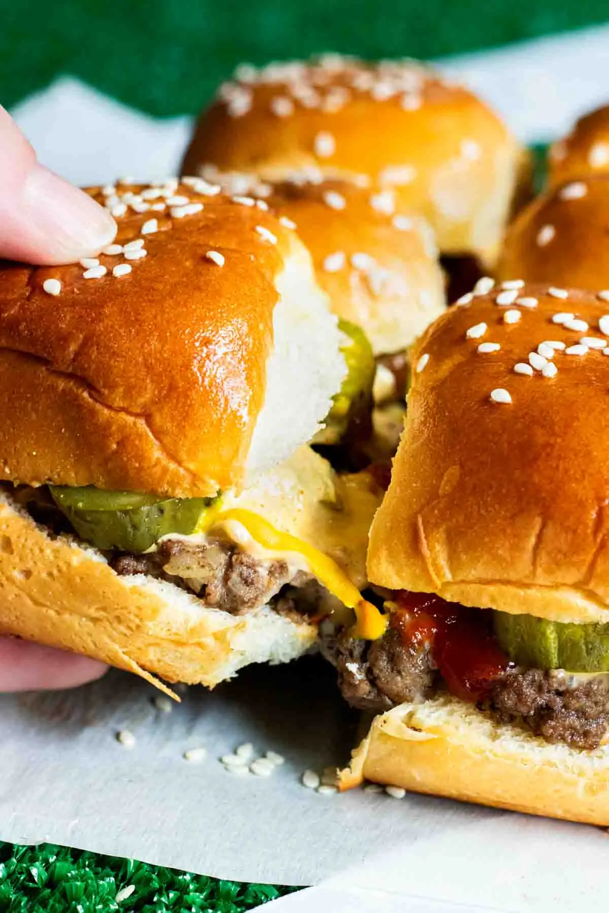 A person is holding a Copycat Big Mac Sliders on a piece of paper.