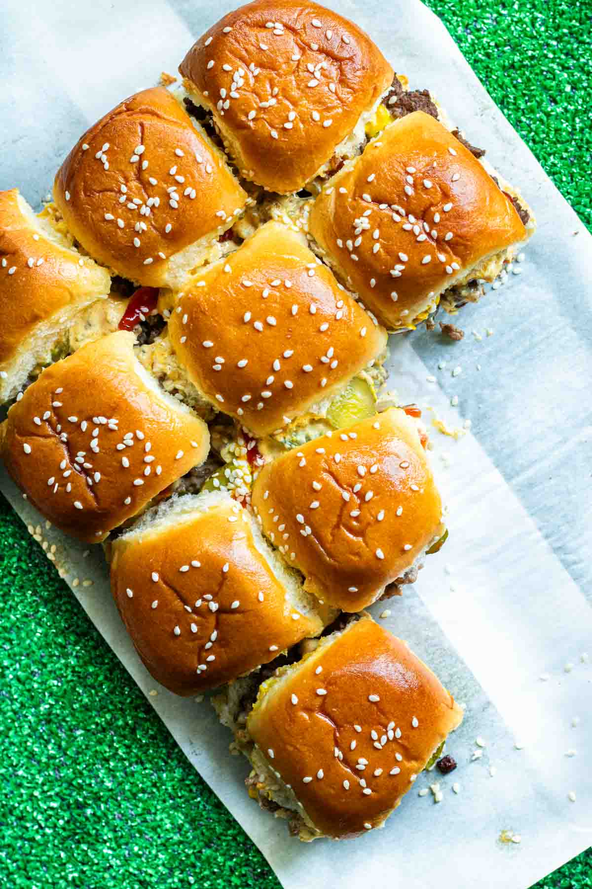 A plate of Copycat Big Mac Sliders with sesame seeds on it.