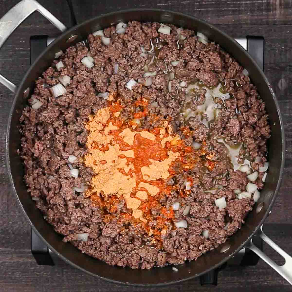 Ground beef in a pan with onions and spices for Beef Enchilada Casserole