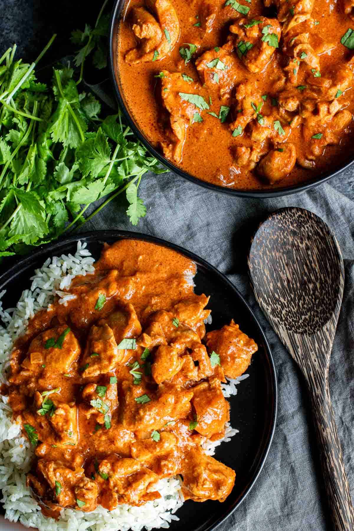 Two bowls of A pot with butter in it for Instant Pot Butter Chicken with rice.