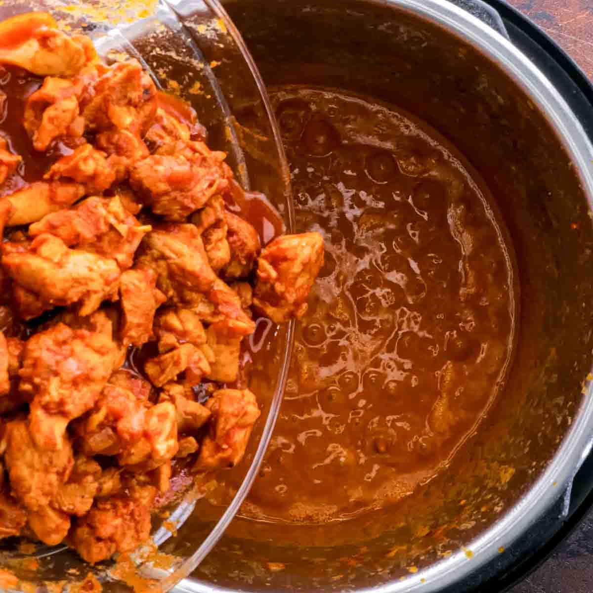 Instant Pot Butter Chicken in a bowl with sauce.